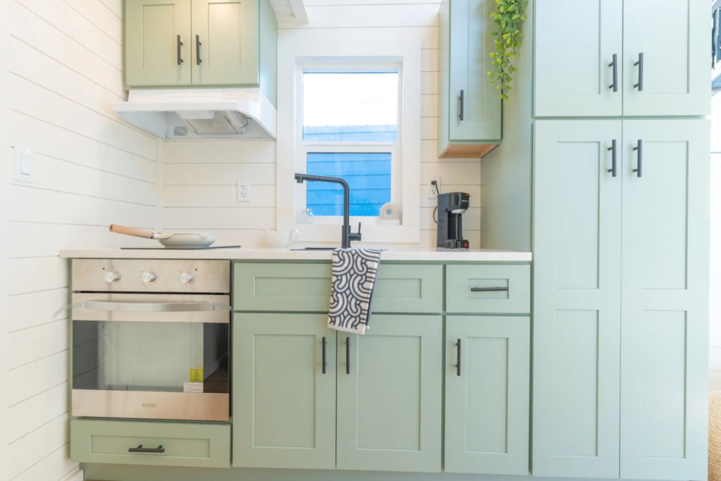 The Genesis 16’ kitchen includes a full-size fridge/freezer, oven, and double induction cooktop