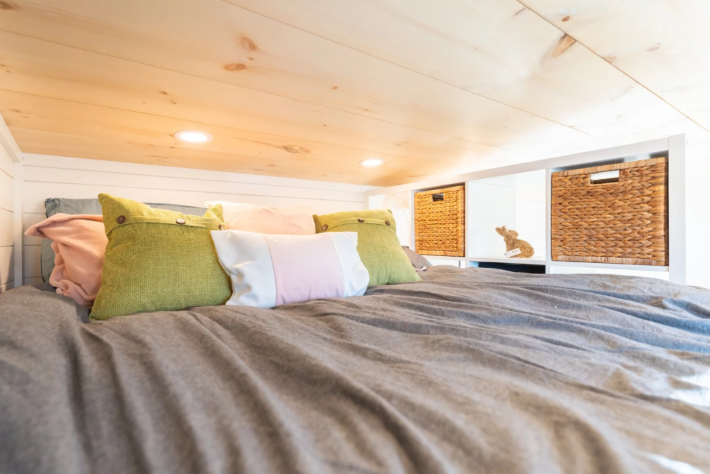 The Genesis 16’ bedroom is located in a loft-style mezzanine space reached by storage-integrated stairs