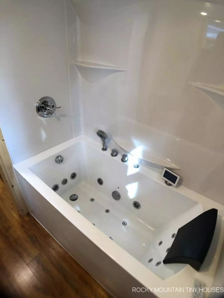 The Bradford 26' Tiny House's bathroom includes a jacuzzi tub