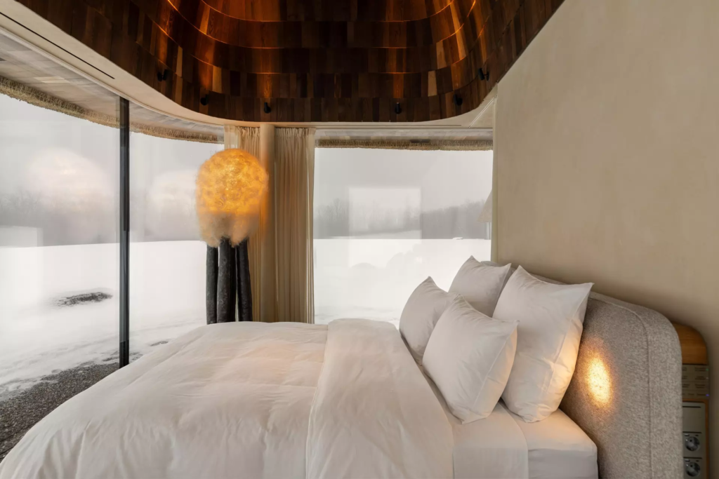 The bedroom features large blinds for privacy