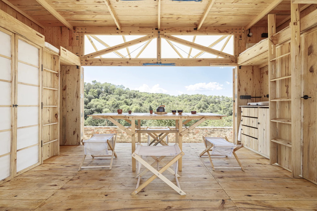 The MO.CA's interior includes a dining table and a kitchen, as well as two bedrooms