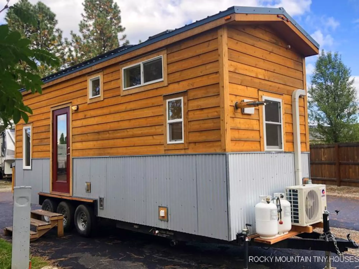 The Bradford 26' Tiny House is a rustic tiny house that hides some big home comforts inside